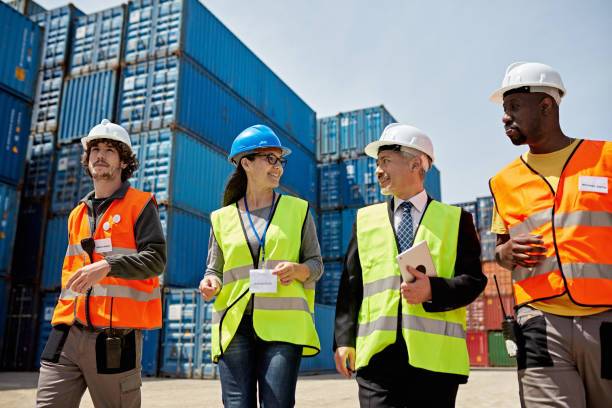 male-and-female-coworkers-walking-side-by-side-in-reflective-vests-and-hardhats