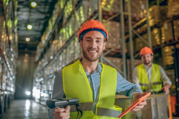 Two warehouse workers in helmets & vests(1)